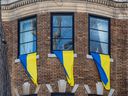 Ukrainian flags hang from the windows of a building across from the Russian consulate in Montreal on March 14, 2022.