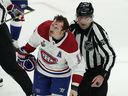 Montreal Canadiens right-wing Brendan Gallagher skates off the ice with linesman Michel Cormier during the third period in Game 1 of the Stanley Cup final against the Tampa Bay Lightning, on June 28, 2021, in Tampa, Fla.