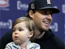 Former Montreal Canadiens defenseman Ben Chiarot speaks to the media with his daughter, Emmerson, during a news conference in Montreal on Thursday, March 17, 2022.