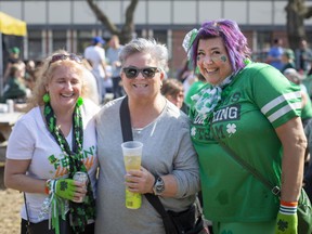 Maria Hamilton, Lola Richard, and Chris Malinowski, attend the St. Patrick's Day festivities at the new WindsorEats location on Erie Street East, Thursday, March 17, 2022.