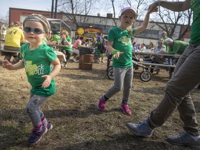 Charlotte Fauteux, 3, and her sister, Laurence Fauteux, 5, dance to the live music with their mother, Christina Fauteux, at the St. Patrick's Day festivities at the new WindsorEats location on Erie Street East, Thursday, March 17, 2022.