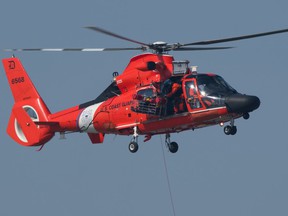 A US Coast Guard helicopter crew rescues a woman kayaker from Peche Island on Wednesday, March 17, 2020.