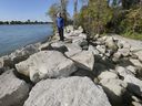 Island rescue.  Windsor Mayor Drew Dilkens is shown on Friday, Oct. 2, 2020, walking along a section of large rocks on Peche Island that were placed to combat shoreline erosion.