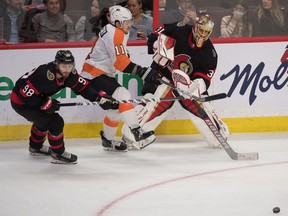Senators goalie Anton Forsberg moves the puck away from Flyers right-winger Travis Konecny ​​in the third period.
