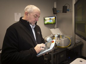 Shawn Horton, director of marketing and business development with AIS Technologies Group, is pictured inside the Demonstration Lab working with a vision based position tracking for robots, on Monday, March 21, 2022.