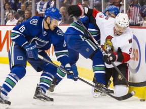 Brad Richardson (left) battles for the puck against Milan Michalek of the Ottawa Senators during a November 2014 NHL game at Rogers Arena.