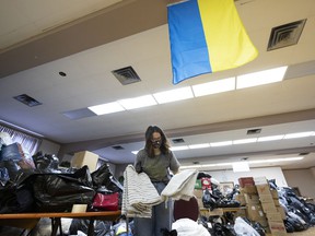 A volunteer sorts through donations in the basement of the Ukrainian Catholic Parish of the Assumption of Blessed Virgin Mary in Rosemont.  Medical supplies are sent to Ukraine, while other items are held for refugees arriving here.
