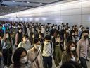 Commuters wear masks at a train station in Hong Kong on March 21, 2022.