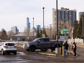 People pay for parking at the Old Strathcona Farmer's Market's weekend parking lot in Edmonton, on Tuesday, March 29, 2022.