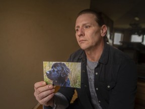 Greg Marentette holds a photo of his dog, Lemmy, who was stolen by his former dog walker three years ago, on Wednesday, March 30, 2022.