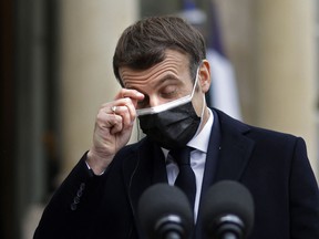 French President Emmanuel Macron gestures as he addresses the press upon the arrival of the Portuguese Prime minister for a working lunch on Dec. 16, 2020.