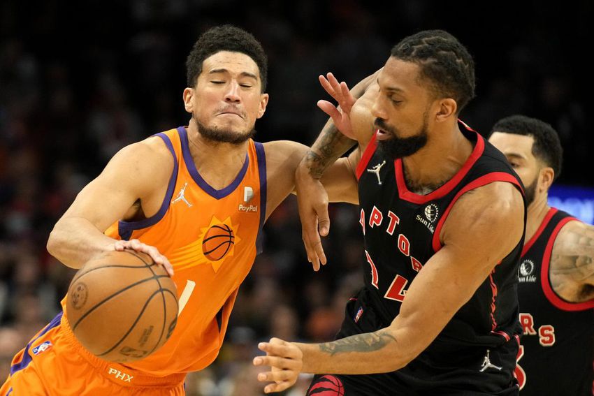 Khem Birch, right, was a defensive force in crunch time of the Raptors' win over Devin Booker and the Suns in Phoenix on Friday night.