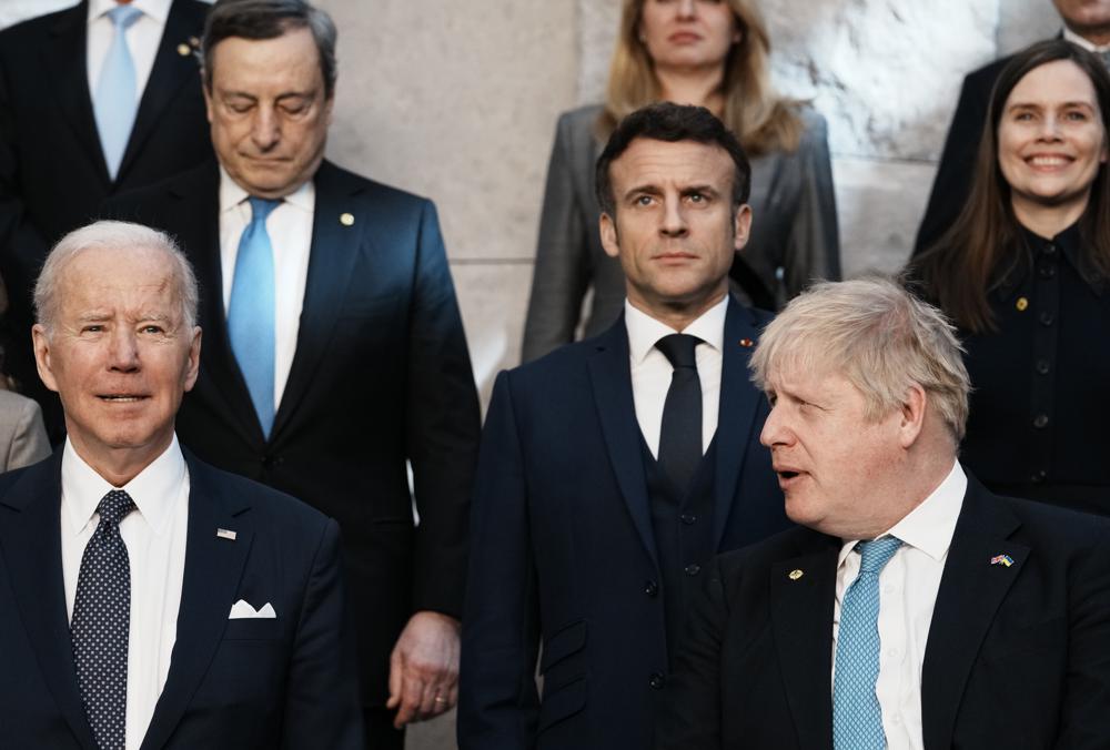 British Prime Minister Boris Johnson, front right, looks toward US President Joe Biden, front left, at a group photo during an extraordinary NATO summit at NATO headquarters in Brussels, Thursday, March 24, 2022. As the war in Ukraine grinds into a second month, President Joe Biden and Western allies are gathering to chart a path to ramp up pressure on Russian President Vladimir Putin while tending to the economic and security fallout that's spreading across Europe and the world.