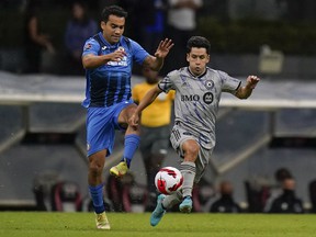 Cruz Azul's Adrian Aldrete, left, and CF Montréal's Joaquin Torres battle for the ball during the teams' CONCACAF Champions League quarter-final match in Mexico City on Wednesday night.