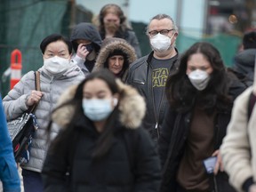 Most people remained masked on Friday — the first day after the provincial mask order was lifted — on Cambie Street at West Broadway.