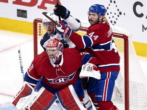 Canadiens defenseman Joel Edmundson checks the Winnipeg Jets' Andrew Copp while goalie Carey Price follows the puck during Game 3 of second-round NHL playoff series last season.