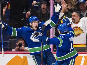 Vancouver Canucks forward Bo Horvat (53) and defenseman Quinn Hughes (43) celebrate Horvat's second goal of the game against the Washington Capitals in the third period at Rogers Arena.  Capitals won 4-3 in overtime.  Photo: Bob Frid-USA TODAY Sports