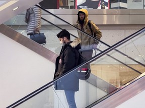 Escalators at the Rideau Center in Ottawa had some customers wearing masks, and some not, Monday, March 21, 2022.