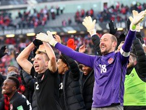 Alistair Johnston (No. 2) and Milan Borjan (No. 18) of Canada celebrate after defeating the United States 2-0 following a 2022 World Cup Qualifying match at Tim Hortons Field on January 30, 2022 in Hamilton.