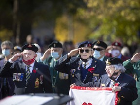 Veterans salute while at attention during the Remembrance Day ceremony in downtown Windsor, on Thursday, Nov. 11, 2021.