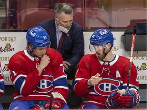 Canadiens interim head coach Martin St. Louis has a conversation with Jake Evans, left, and Paul Byron during a game last month at the Bell Center.