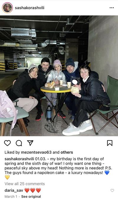 Sasha Korashvili, her boyfriend Dmitriy Bricheck and friends pose for a picture on her birthday while hiding underground in her Kyiv apartment's parking garage on March 1.