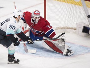 Seattle Kraken's Marcus Johansson scores against Canadiens goaltender Sam Montembeault during NHL shootout hockey action in Montreal on Saturday, March 12, 2022.