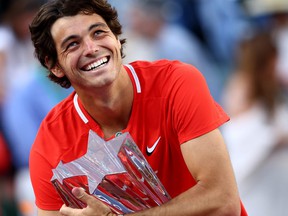 Taylor Fritz of the United States holds his winners trophy after his straight sets victory against Rafael Nadal of Spain in the men's final of the BNP Paribas Open at the Indian Wells Tennis Garden on March 20, 2022 in Indian Wells, Calif.