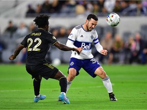 Vancouver Whitecaps midfielder Russell Teibert (31) plays for the ball against Los Angeles FC forward Kwadwo Opoku (22) during the first half at Banc of California Stadium.