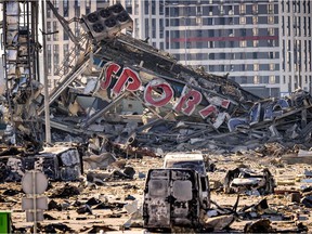 A picture taken on March 21, 2022 shows a view of the damage at the Retroville shopping mall, a day after it was shelled by Russian forces in a residential district in the northwest of the Ukranian capital Kyiv.  - At least six people were killed in the bombing.  Six bodies were laid out in front of the shopping mall, according to an AFP journalist.  The building had been hit by a powerful blast that pulverized vehicles in its car park and left a crater several meters wide.