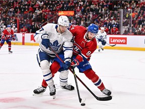 Toronto Maple Leafs' Pierre Engvall and Canadiens' William Lagesson (84) fries for position to the puck during the first period at the Bell Center on Saturday, March 26, 2022, in Montreal.