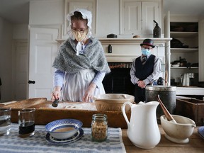 Kate Rosser-Davies and Greg Trepanier are shown in the kitchen of the main house during the maple syrup celebration at the John R. Park Homestead on Saturday, March 19, 2022.