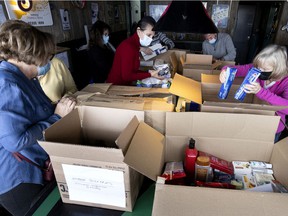 Volunteers sort a steady stream of donations bound for Ukraine as Montrealers drop items off at Duffy's pub on Sunday, March 13, 2022.