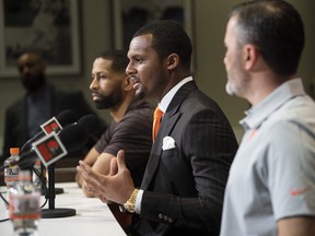 Cleveland Browns quarterback Deshaun Watson (center)talk with the media during a news conference.