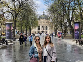 Stefania Kostiuk (left) and sister Natalia pose last year in front of Andrew's Church, a major Baroque church at the top of Andriyivskyy Descent in Kyiv.