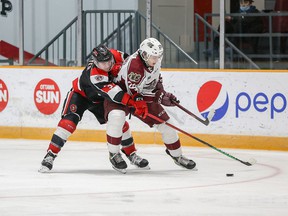 Teddy Sawyer of the 67's, left, applies defensive pressure on Sam Alfano of the Petes during Friday's game at TD Place arena.