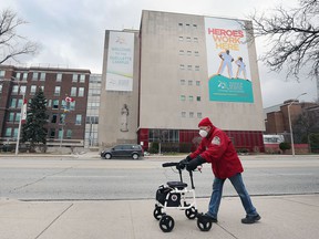 A man walks by the Windsor Regional Hospital Ouellette Campus on Friday, March 25, 2022.