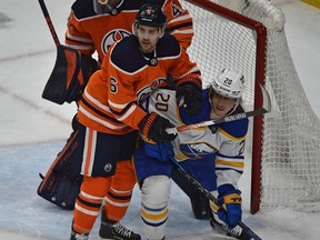 Edmonton Oilers defenseman Kris Russell (6) keeps the Buffalo Sabers' Cody Eakin (20) in check at Rogers Place in Edmonton on Thursday, March 17, 2022.
