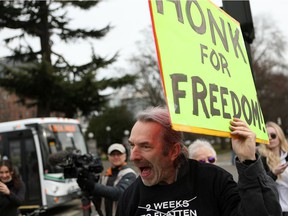 Supporters gather near the legislature to protest during a demonstration against COVID-19 restrictions in Victoria, Saturday, Feb. 5, 2022.