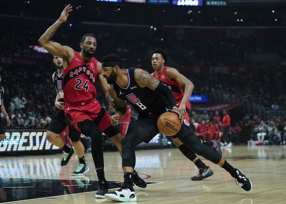 Toronto Raptors center Khem Birch (24) defends against Los Angeles Clippers forward Marcus Morris Sr. (8) during the first half of an NBA basketball game in Los Angeles on Wednesday, March 16, 2022.