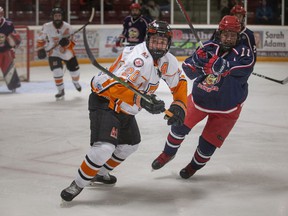 ESSEX, ONTARIO:.  MARCH 13, 2022 - Essex' Conor Dembinski and Petrolia's Peyton Armitage battle for the puck in game 3 of the Junior C hockey playoffs between the Essex 73's and the Petrolia Flyers at the Essex Center Sports Complex, on Sunday, March 13, 2022.