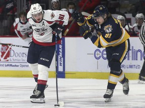 Windsor Spitfires' forward Matthew Maggio, left, battles Erie Otters' forward Brendan Hoffmann earlier this season.  Maggio had two goals and an assist in Friday's 6-4 road loss to Erie.