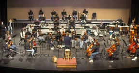 Students from the Toledo School for the Arts rehearse with the Windsor Symphony Youth Orchestra at the Capitol Theatre, on Friday, March 11, 2022.