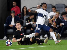 Tristan Blackmon dispossesses Yordi Reyna of the ball during a 6-1 LAFC win at Banc of California Stadium in 2019. Blackmon, traded to Vancouver in the off-season, just signed a two-year extension and will play his former club on Sunday.