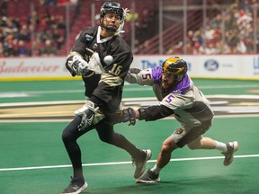 Mitch Jones of the Vancouver Warriors carries the ball past the San Diego Seals' Conner Fields during a December 2019 NNL game at Rogers Arena.