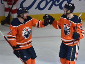 Edmonton Oilers Connor McDavid (97) celebrates his goal with Duncan Keith (2) against the Detroit Red Wings during NHL action at Rogers Place in Edmonton, March 15, 2022. Ed Kaiser/Postmedia