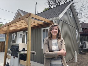 Sarah Cipkar poses next to her tiny home in Windsor on Tuesday, April 27, 2021. Cipkar will be participating in a study on the impact of tiny homes in the area.