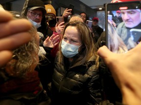 Convoy protest organizer Tamara Lich (wearing a mask) leaves after being released on bail at the Ottawa courthouse on Monday.