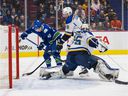 St. Louis Blues defenseman Marco Scandella (6) looks on as goalie Ville Husso (35) makes a save on a shot by Vancouver Canucks forward Elias Pettersson (40) in the first period at Rogers Arena.