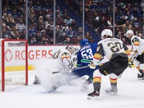 Vegas Golden Knights goalie Robin Lehner (90) stops Vancouver Canucks' Bo Horvat (53) during the first period of an NHL hockey game in Vancouver, BC, Sunday, April 3, 2022.